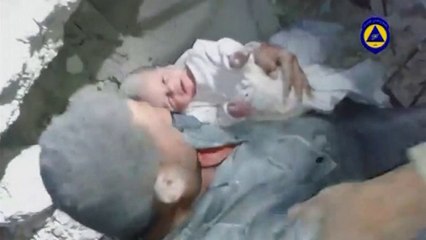 A baby is rescued from rubble in northern Syria