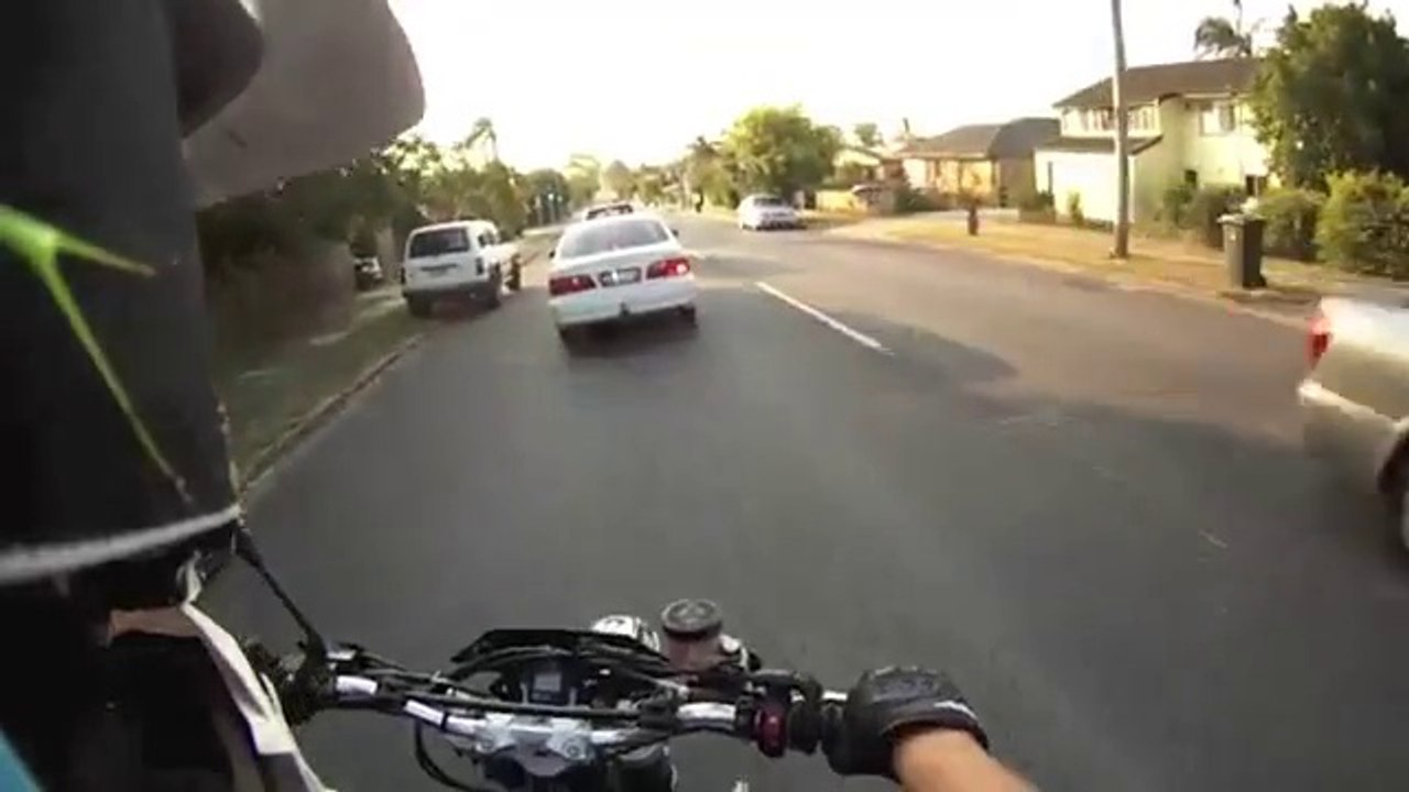 Incredible motorcycle accident! Biker on the roof of the car!