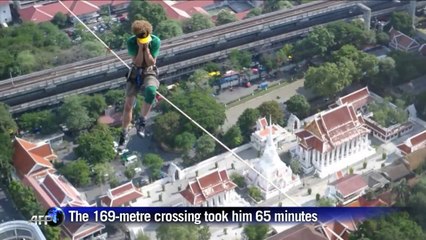 US daredevil walks a highline across Thai buildings