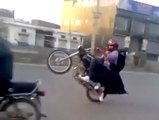 Pakistani Boy One Wheeling With Girl in Burqa