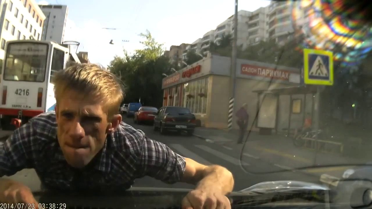 Crazy russian guy jump on a riding car and threat the girl driving! So scary moment...