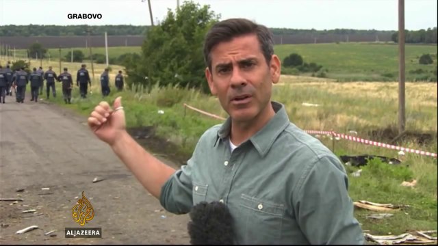 Rescuers comb through debris at Malaysia Airlines crash site