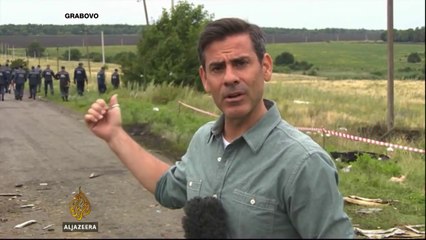 Rescuers comb through debris at Malaysia Airlines crash site