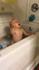 Adorable baby can't get washcloth off his head