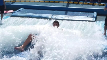 Amateur Surfers Wiping Out on a Surf Machine