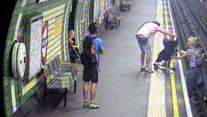 Terrifying moment child in a buggy is blown on to tracks