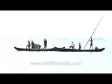 Boatmen pull the fishing nets - Kerala