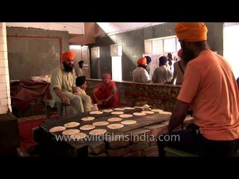 Volunteers cook chapatis in the Golden temple kitchen, Amritsar, India