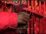 Devotees tie sacred thread at entrance of Amarnath Temple