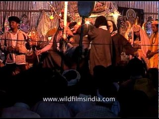 Group of men dance wearing mask at night - Amarnath Yatra