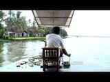 Boatman steering the way along backwaters - Kerala