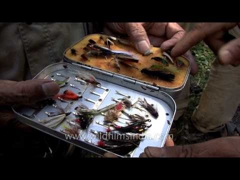 Angler with equipment and tackle - ready for trout fishing in Kashmir