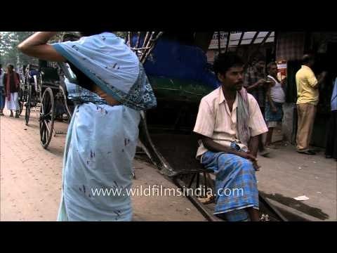 Hand-drawn rickshaw pullers wait for passengers in Kolkata