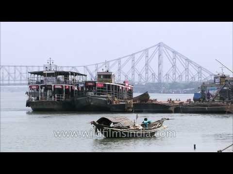 Ferries on river Hooghly against the backdrop of Howrah Bridge