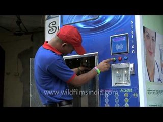 Fill a 20 litre bottle at the Swajal water hut