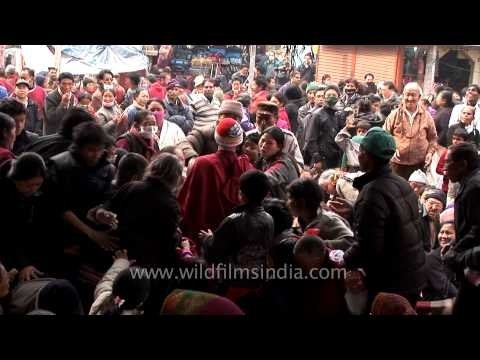 Young monks distribute headbands to devotees - 32nd Kalachakra, Bodhgaya