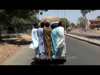 Crowded van outdoor ride: Men in kurta suits ride open tempo in Rajasthan
