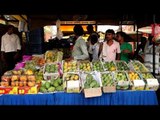 Visitors look at varieties of mangoes on display in Delhi