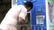 Residents fill bottles with pure drinking water from Swajal machine