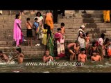 Devotees take a holy bath in River Ganges - Varanasi