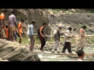 People crossing makshift bridge during Maund Mela 2014