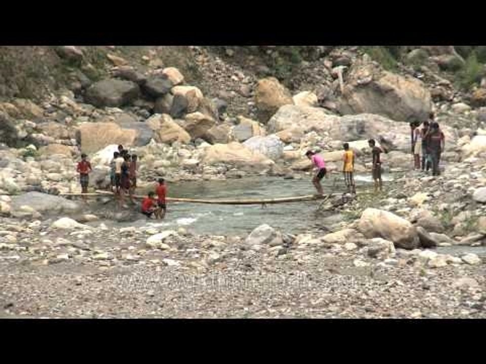 Villagers cross makeshift bridge in Uttarakhand to kill all the fish in the river
