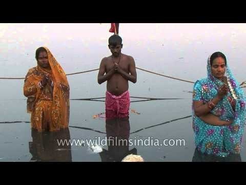 Indian women offers prayer to Sun god on the banks of Yamuna, Delhi