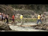 Villagers cross makeshift bridge over Aglar river