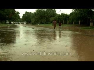 Vehicles drive through flood water in Delhi