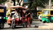 Electric rickshaw and CNG auto on the streets of Delhi