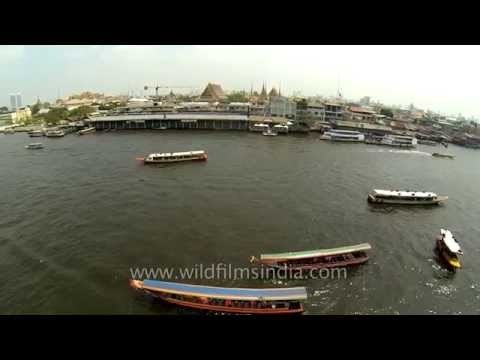 Boat traffic on Chao Phraya river in Bangkok, Thailand