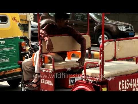 Rickshaw driver relaxing and waiting for passengers