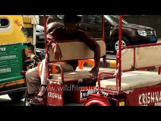 Rickshaw driver relaxing and waiting for passengers
