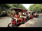 Electric rickshawala waiting for passengers in bright sun light