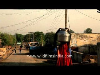 Woman carrying water vessel effortlessly