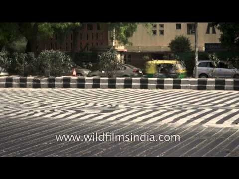 Traffic moves along a busy road in New Delhi
