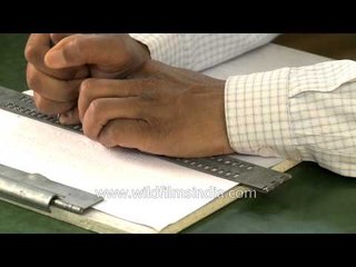 Use of braille slate and stylus by visually challenged man for writing