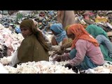Women workers sorting waste paper at a recycling yard in India