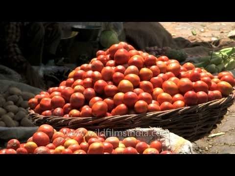 Vendors sell vegetables at wholesale vegetable market