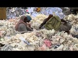 Workers sorting waste paper for recycling at a recycling yard in India