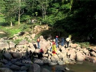 Men collect water from a dirty pond in Assam