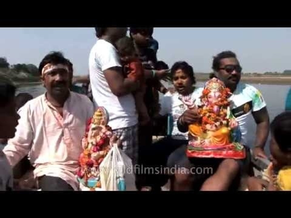 Devotees carrying idols of the Hindu elephant god Ganesh for immersion