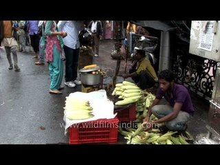 Men selling corn at a roadside in Mussoorie