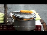 Roadside vendor selling roasted corn in Mussoorie