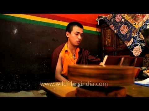 A monk performing rituals at Buddhist temple, Delhi