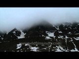 Clouds over snow covered mountains of Kedarnath