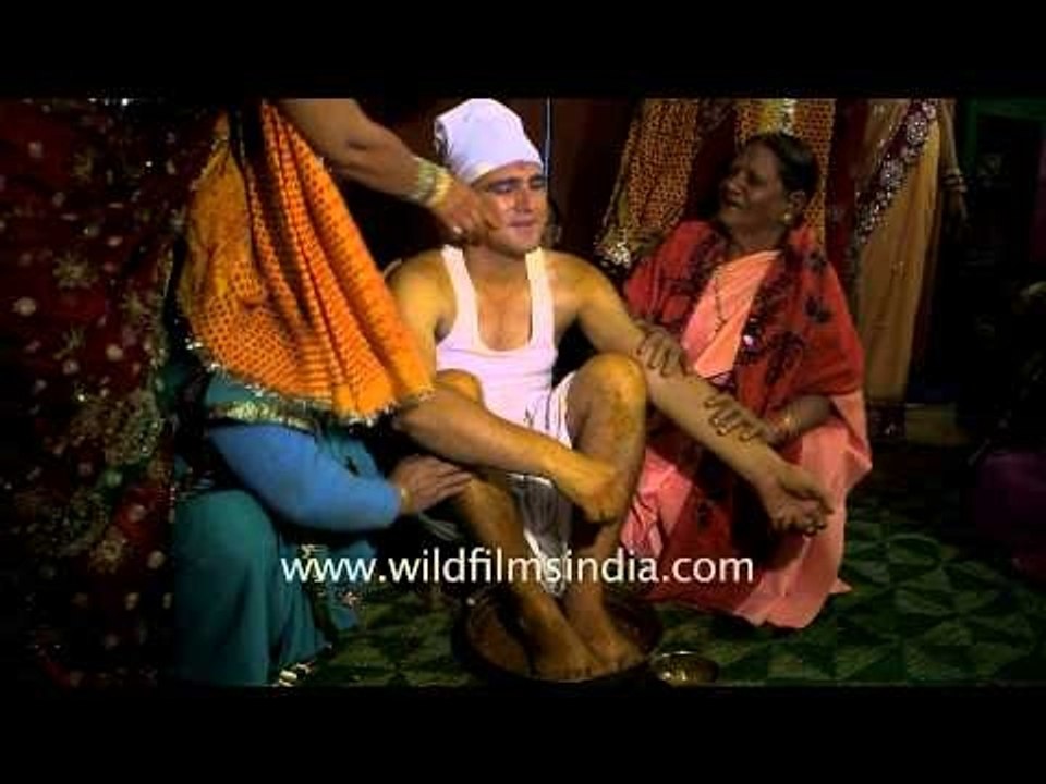 Relatives applying 'haldi' to the groom : Kumaoni wedding