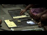 Workers preparing Indian sweets