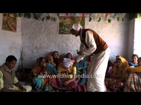 Groom's father performing rituals during a havan before wedding