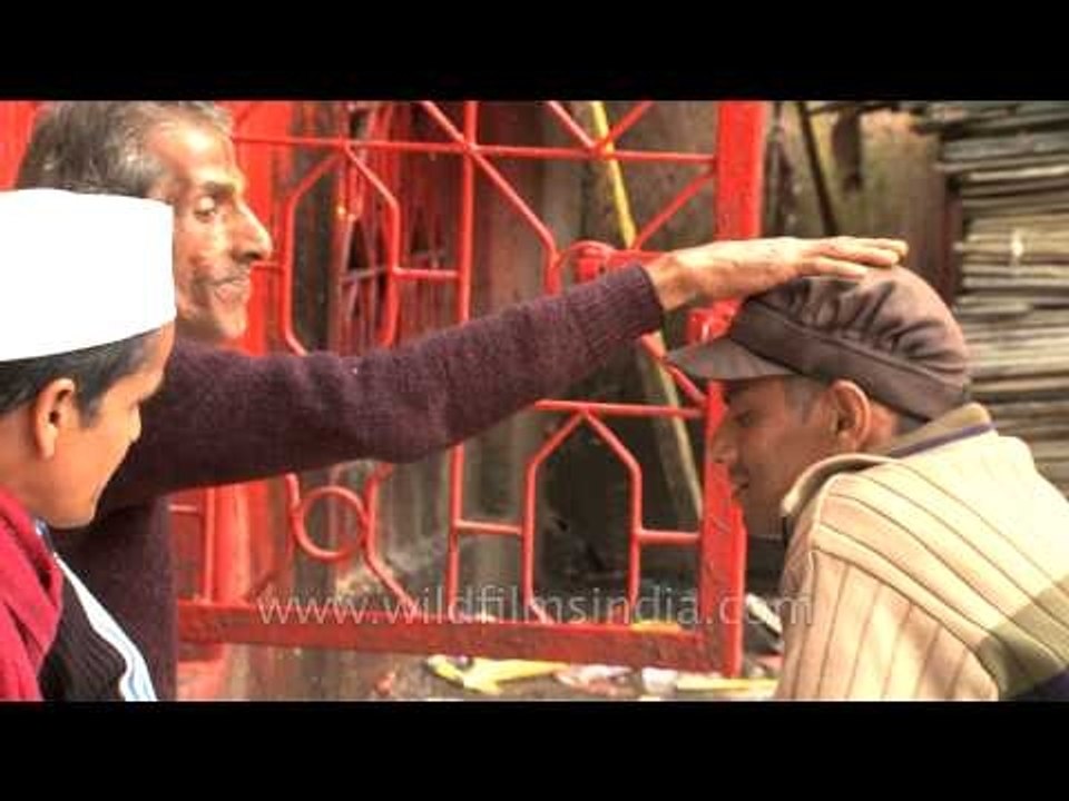 Hindu priest tying a sacred thread and blessing devotees
